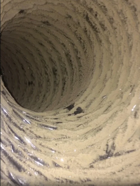 Interior ductwork with dust and debris accumulation on spiral-wound duct walls