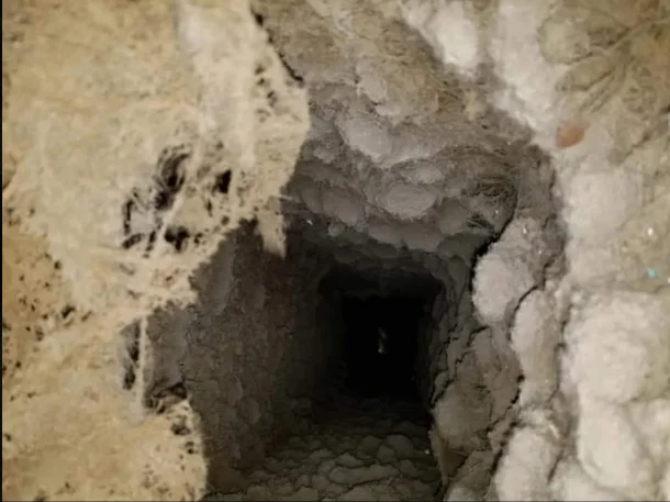 HVAC duct interior with dust and debris accumulation on walls