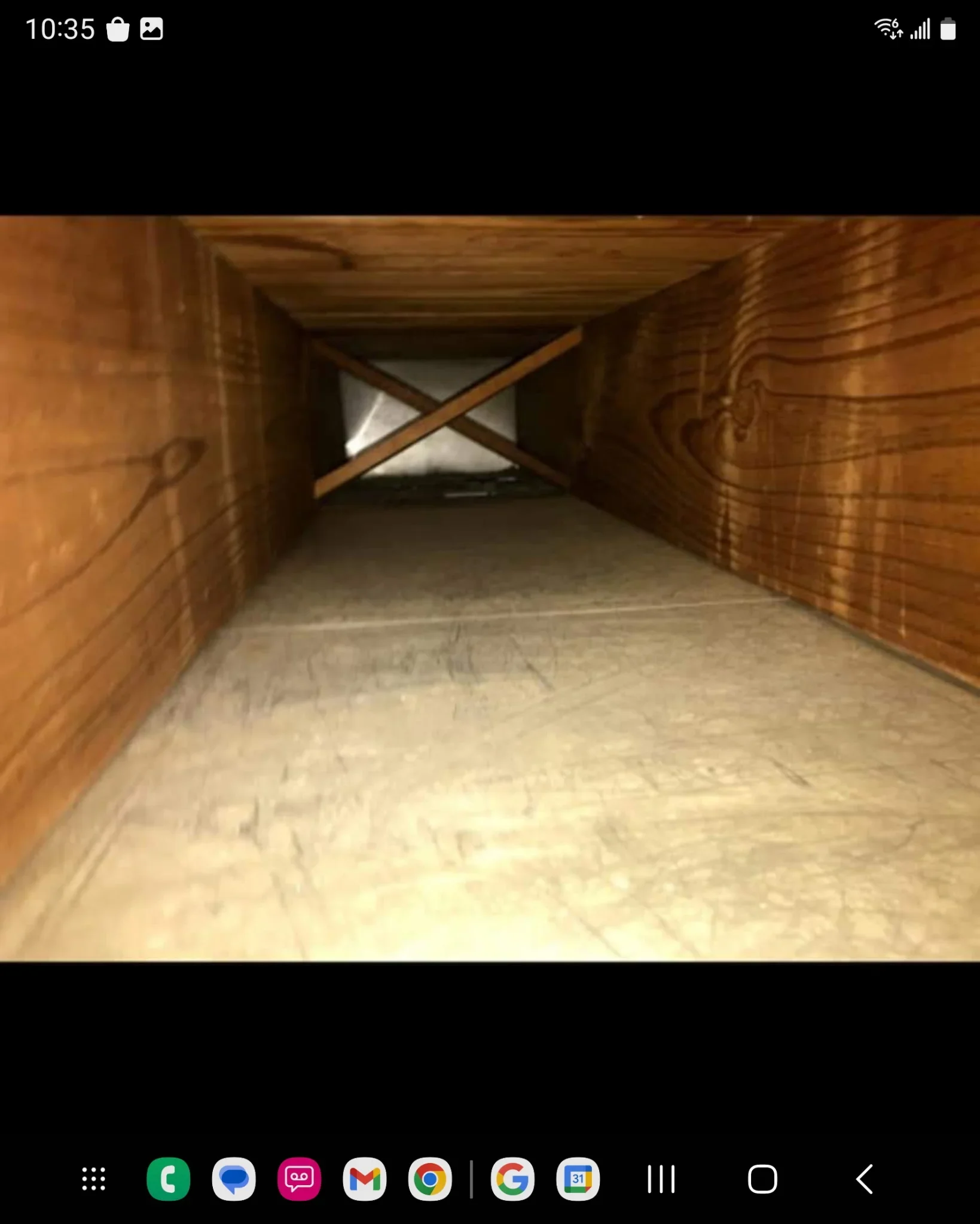Attic interior with wooden framing, cross-bracing, and sealed floor preparation for HVAC installation
