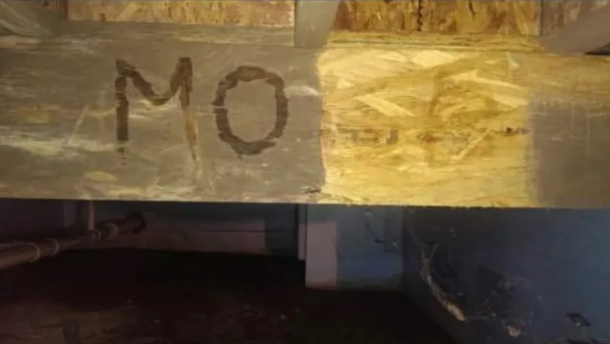 Yellow fiberglass insulation wrapped around HVAC ductwork in basement or crawl space