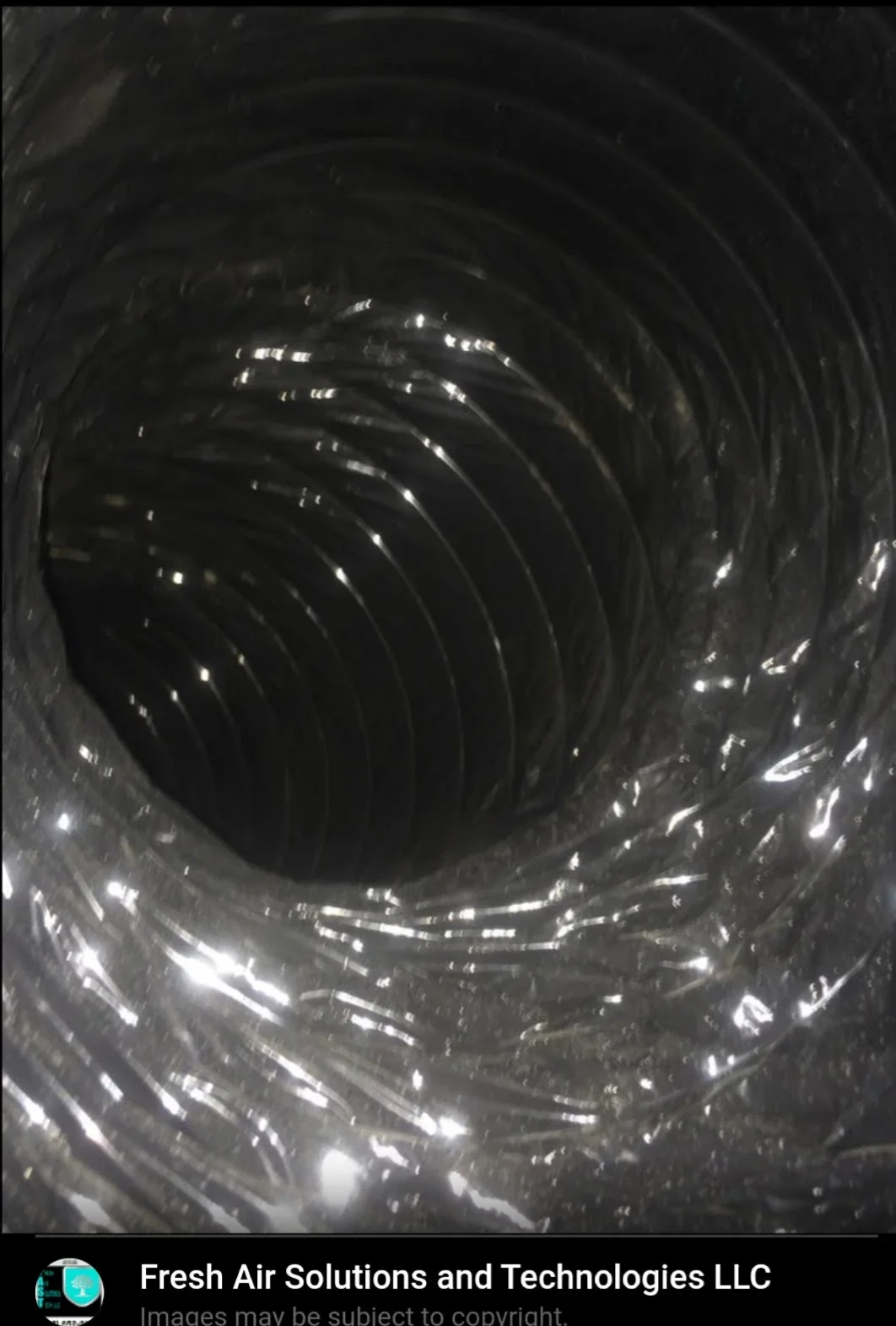 Interior view of dryer vent ductwork with lint buildup on flexible metal ducting walls